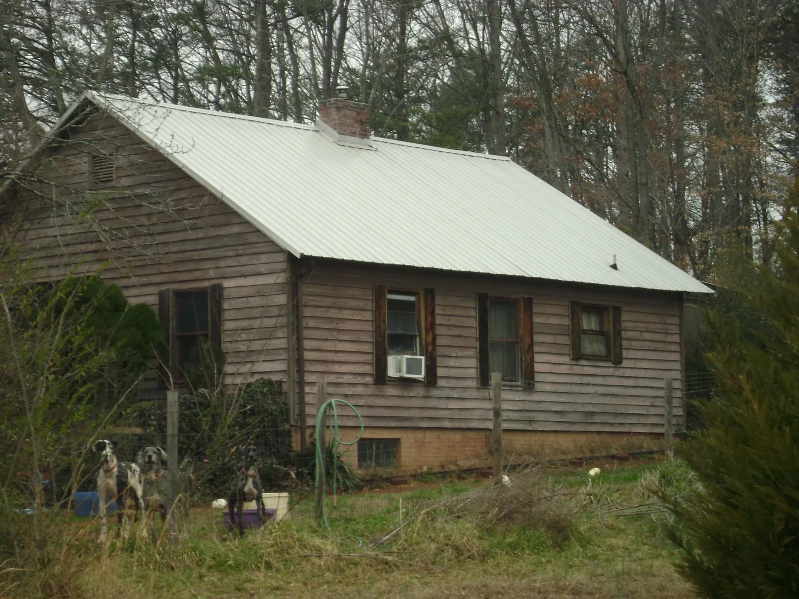 White metal roof on an old wood sided farmhouse, from a Metal Roof Installation job in Clay Center